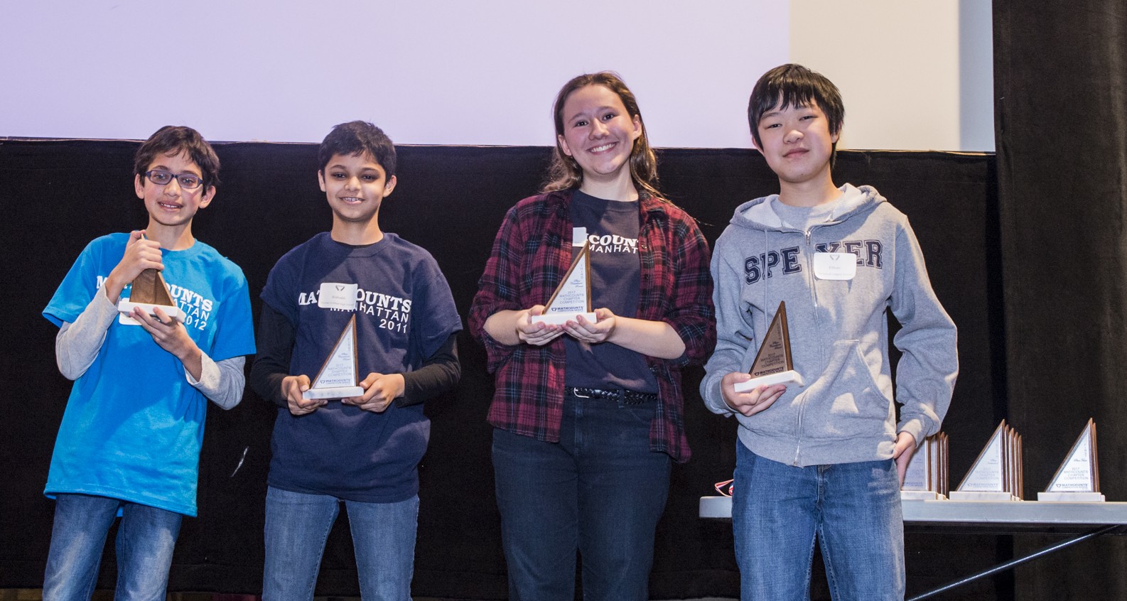 4 students holding trophies