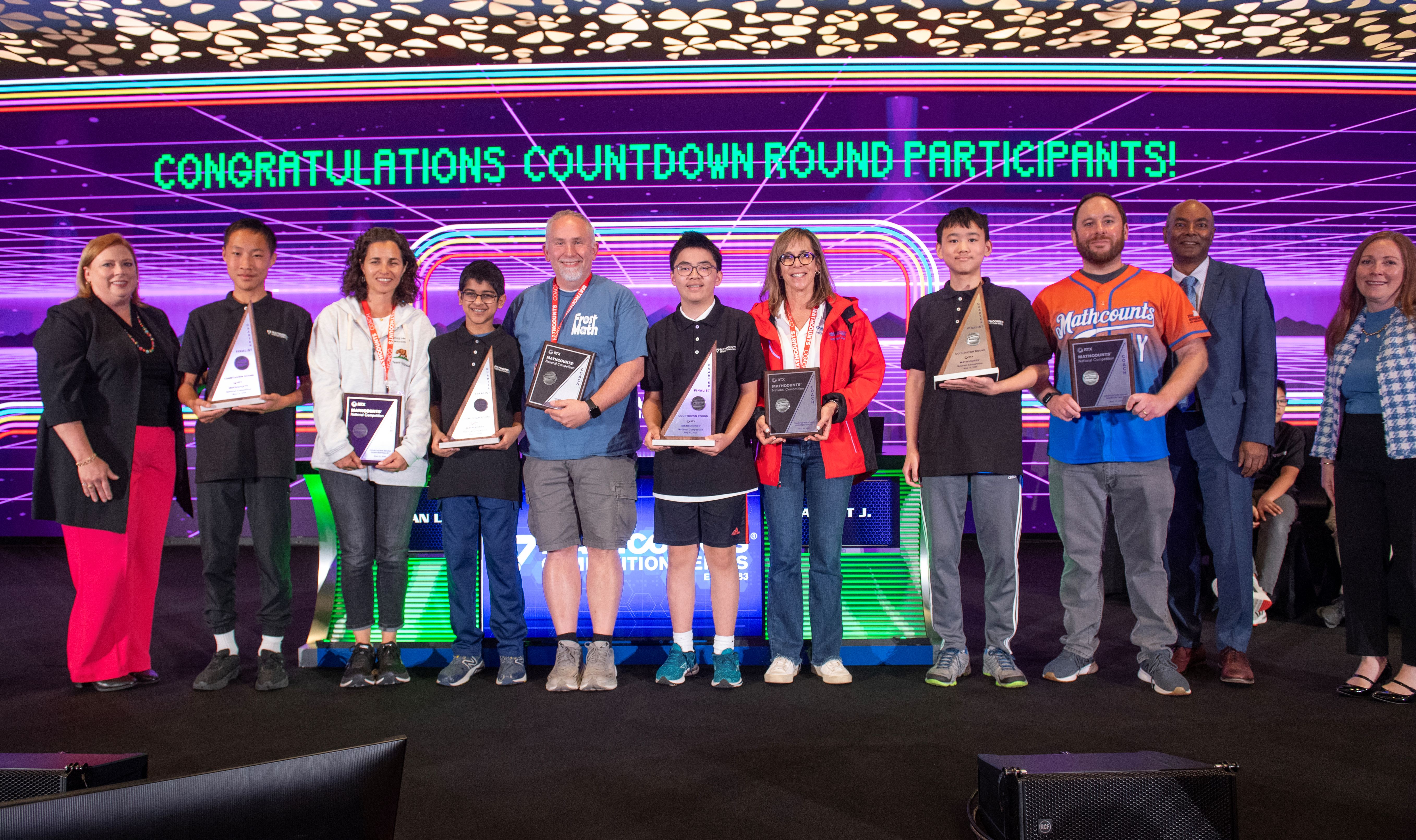 Photo of 2025 quarterfinalists holding trophies