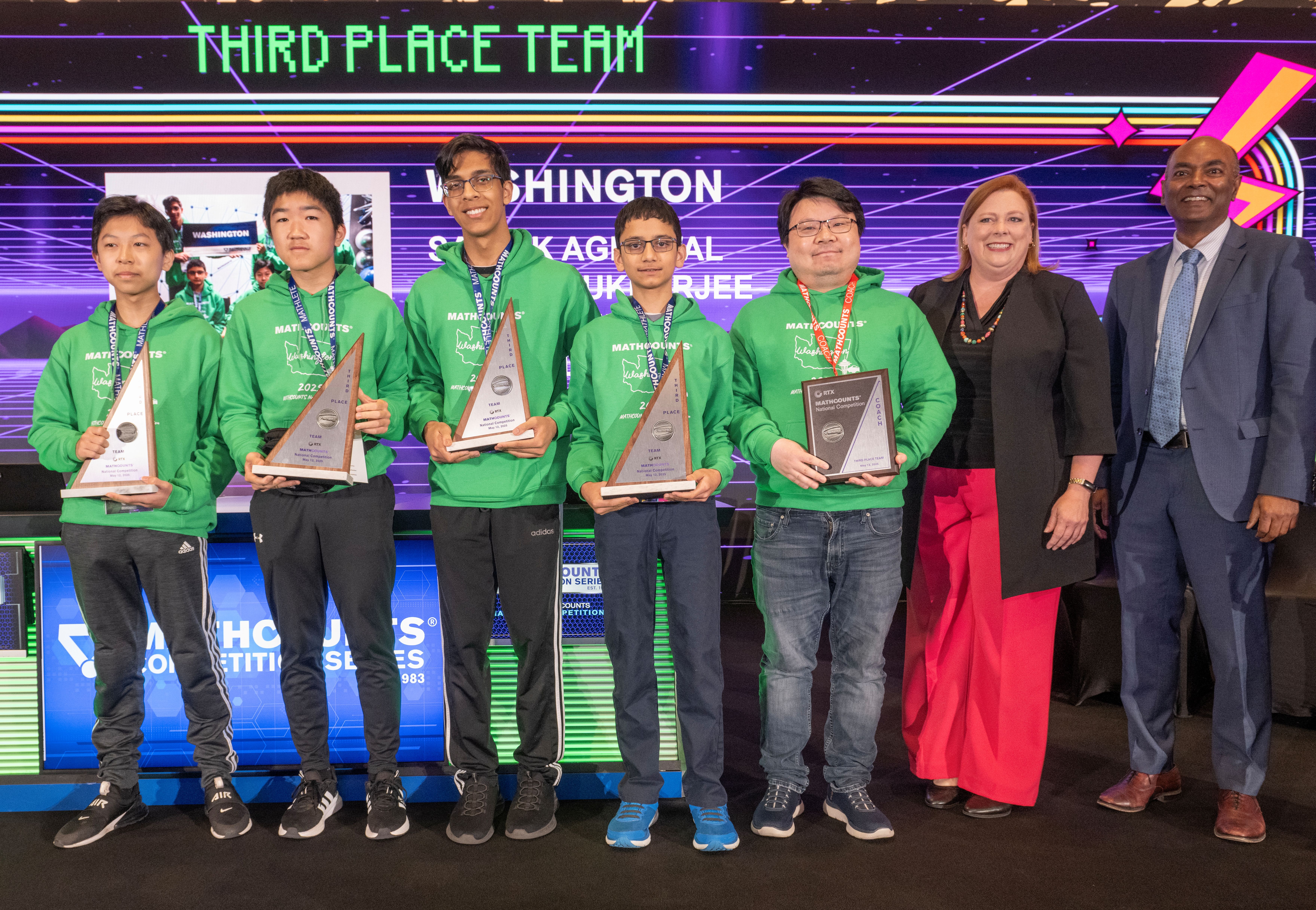 Washington team holding trophies with MATHCOUNTS representatives.