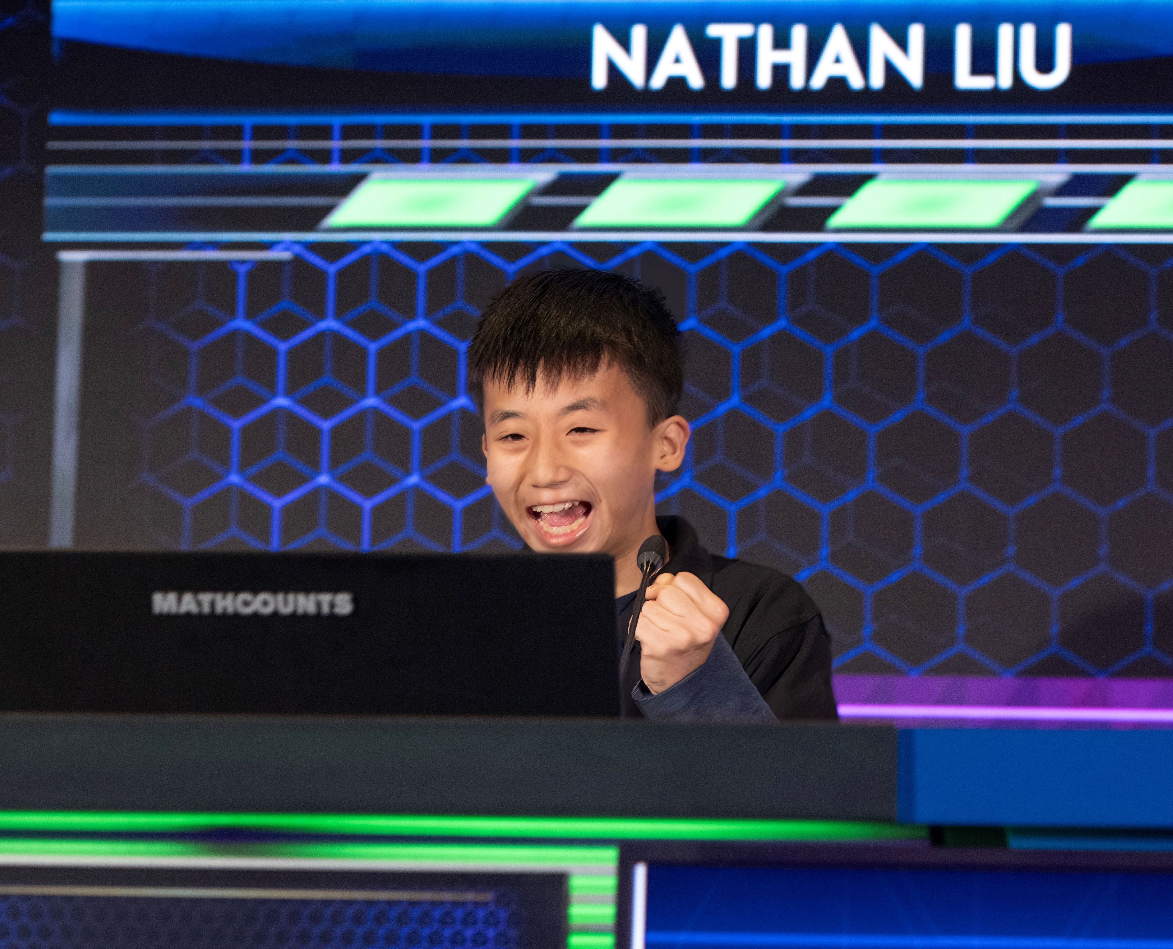 Nathan cheering and holding his fist up.