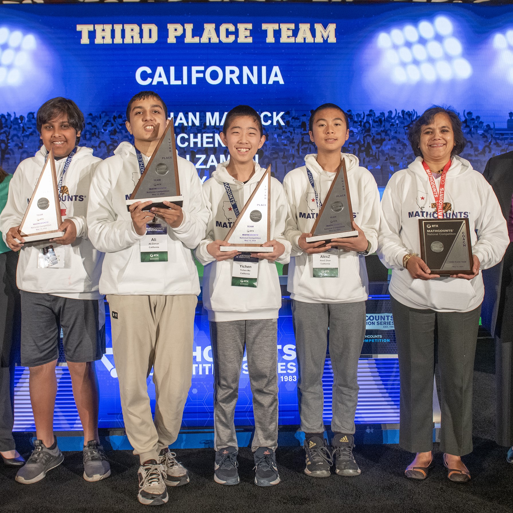 California team onstage with their trophies