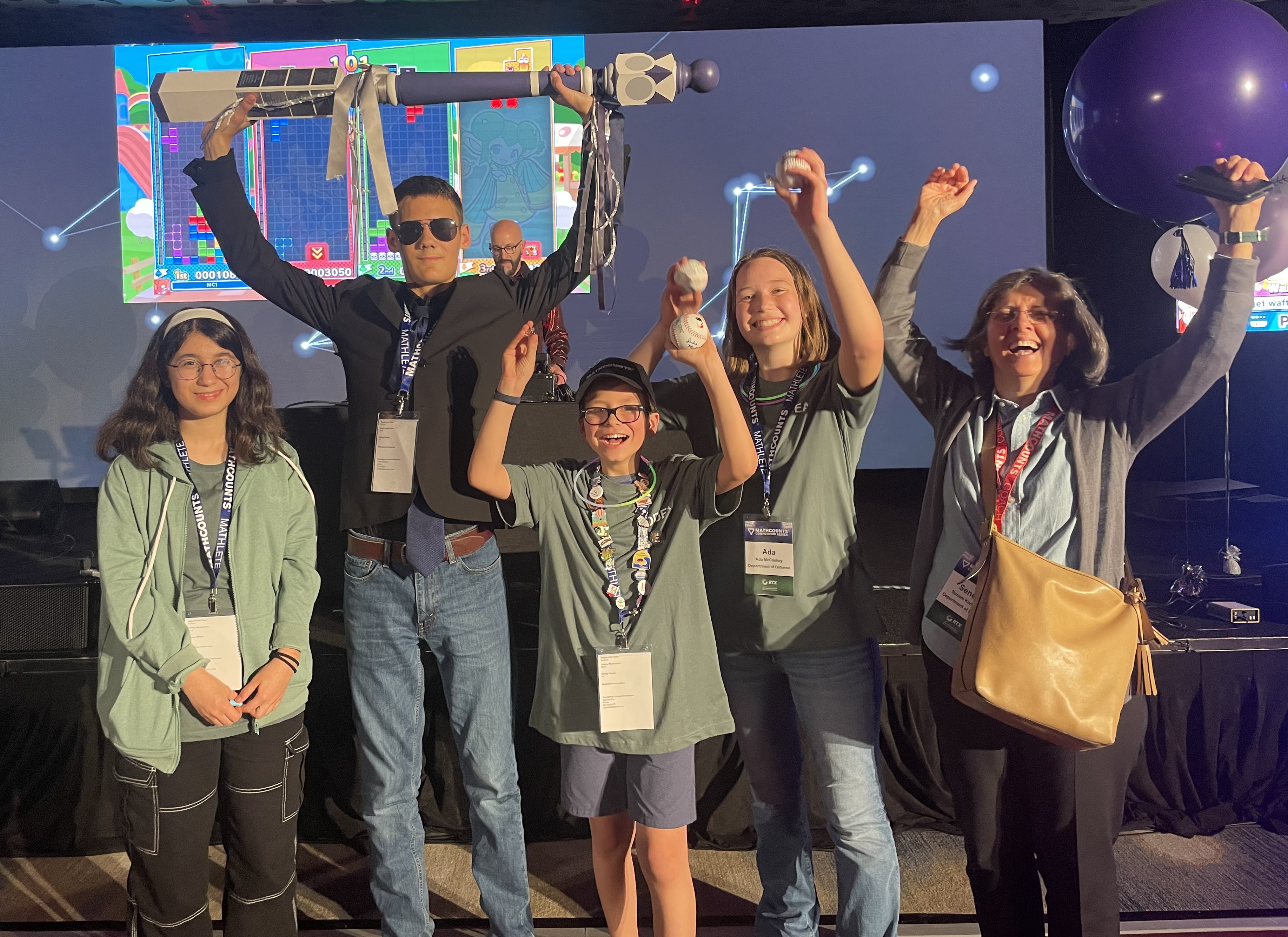 DoD team cheers with the spirit stick at party